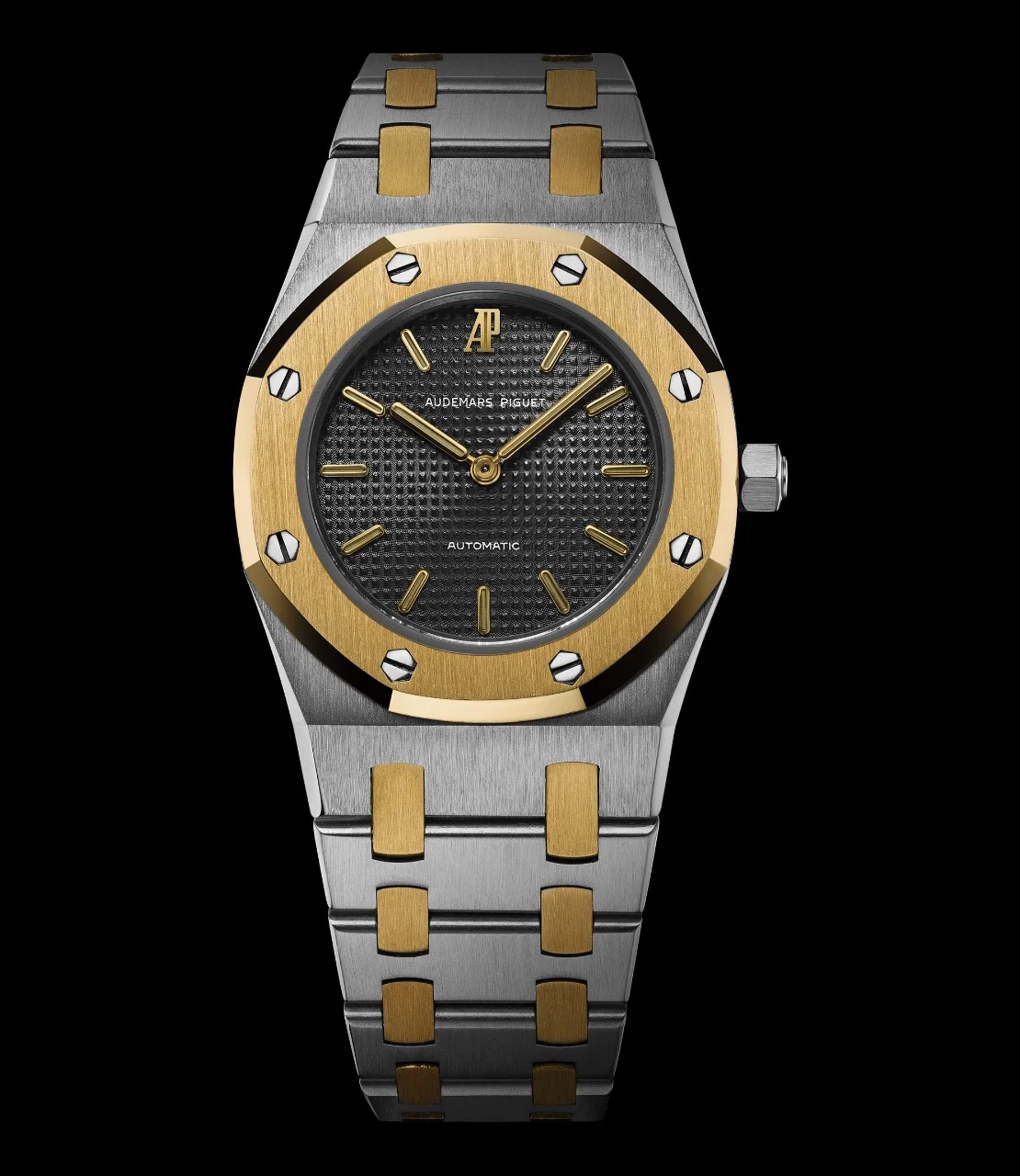 Two-tone 8638SA No. 671 (1977): steel case and bracelet with yellow-gold bezel and links, slate-grey Tapisserie dial with gold markers and AP at 12. · Photo: Audemars Piguet · Licence pending · Source: https://apchronicles.audemarspiguet.com/en/model/8638