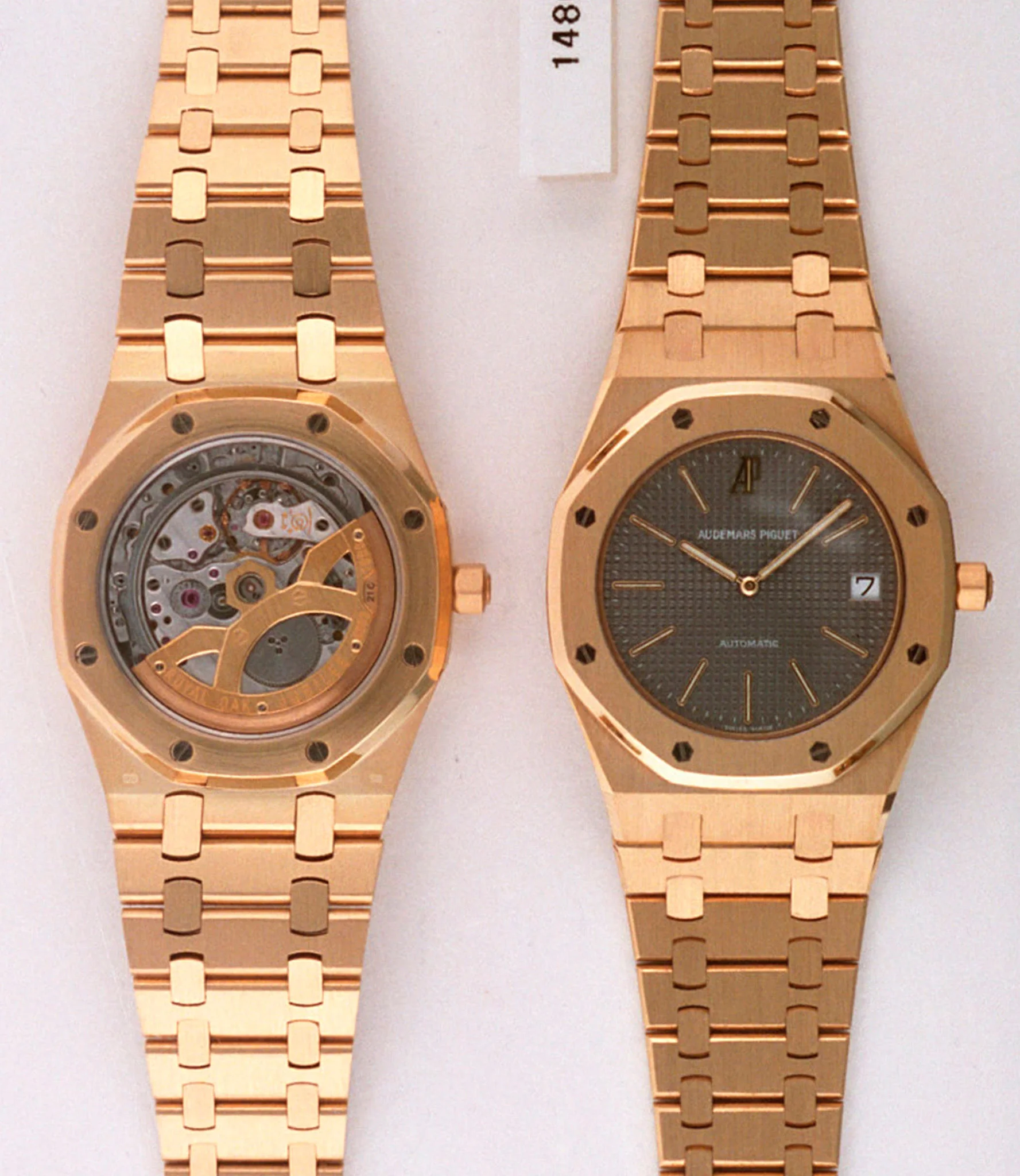 AP identification photograph, front and back, of a yellow-gold 14802BA with the slate-grey Tapisserie dial and gold markers; caseback shows the anniversary rotor. · Photo: Audemars Piguet · Licence pending · Source: https://apchronicles.audemarspiguet.com/en/model/14802-royal-oak-jubilee